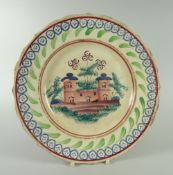 A RARE LLANELLY PLATE WITH CASTLE SCENE and sponged decoration to the border, 23cms diam Condition