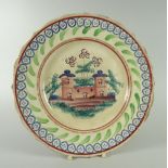 A RARE LLANELLY PLATE WITH CASTLE SCENE and sponged decoration to the border, 23cms diam Condition