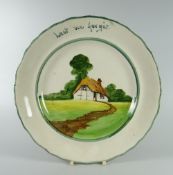 A LLANELLY POTTERY REMEMBERANCE PLATE the border inscribed 'lest we forget' and with a thatched