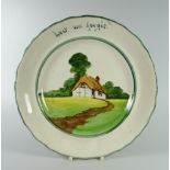 A LLANELLY POTTERY REMEMBERANCE PLATE the border inscribed 'lest we forget' and with a thatched