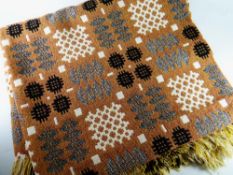 A GOOD TRADITIONAL WELSH WOOLEN BLANKET of brown ground with black, grey and white geometric