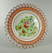 A SWANSEA POTTERY RIBBON PLATE with basket-weave moulded border, chocolate trim and colourful floral