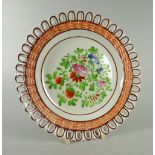 A SWANSEA POTTERY RIBBON PLATE with basket-weave moulded border, chocolate trim and colourful floral