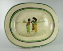 A LLANELLY POTTERY 'DUTCH BOYS' PLATTER with the three boys in conversation while smoking with