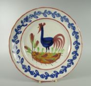 A LLANELLY COCKEREL PLATE typically decorated with sponged leaves to the border, 25cms diam
