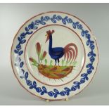 A LLANELLY COCKEREL PLATE typically decorated with sponged leaves to the border, 25cms diam