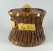 A BUCKLEY POTTERY TOBACCO JAR & COVER of waisted form with bark texture, with slip knop and panel