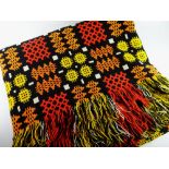 A GOOD TRADITIONAL WELSH WOOLEN BLANKET of black ground with red, orange and mustard geometric