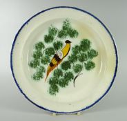 A POSSIBLY SWANSEA CREAMWARE PLATE with naive perched bird decoration, the combed border painted