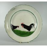 A LLANELLY POTTERY COCK & HEN DECORATED PLATE with slightly wavy border, marked LLANELLY to base,