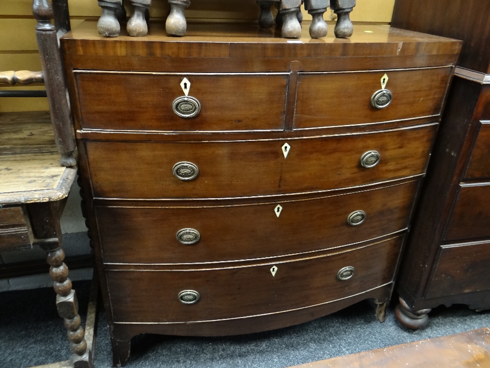 An antique bow front mahogany chest of three long & two short drawers (requires some attention)