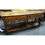 An antique oak Welsh dresser base with open platform & two drawers over a shaped frieze, 176cms