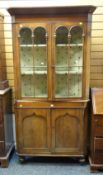 An antique Welsh oak farmhouse two-stage corner cupboard with cupboard base & arched glazed