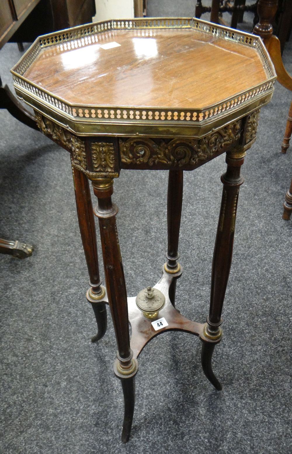 A rosewood & metallic galleried planter stand in the French-Empire style