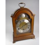 A good Elliott reproduction dome-topped & engraved brass face bracket clock with silver dial bearing