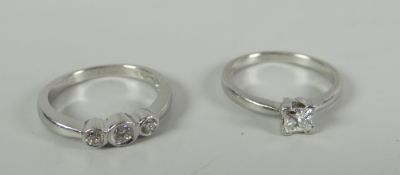 A three-stone diamond platinum ring & a single-stone similar