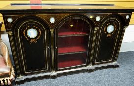 An antique ebonized & inlaid credenza composed of flanking arched enclosed cupboards & centre glazed