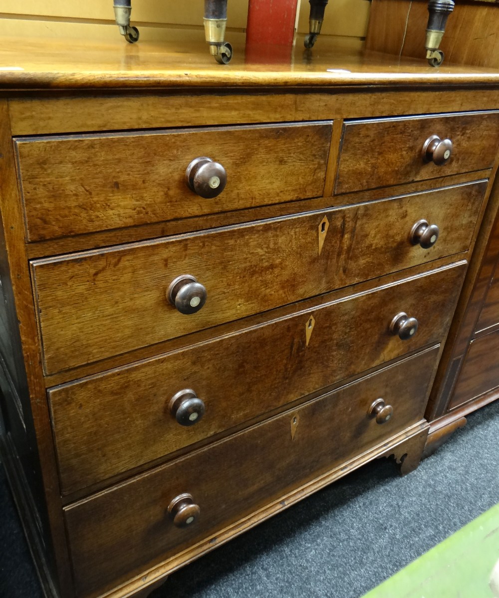 A good antique oak chest of three long & two short drawers on carved bracket feet, with mother-of-