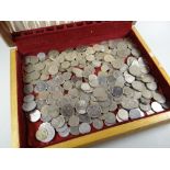 A cutlery canteen box containing a quantity of silver-coloured coinage
