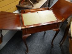An antique Edwardian mahogany ladies writing desk with fold-up mechanism revealing pigeon holes &