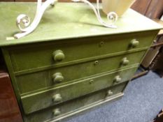 An antique green painted pine chest of four drawers