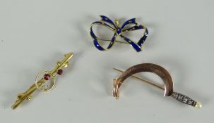 An enamel & yellow metal bow brooch, a 9ct gold floral bar brooch & a believed gold brooch in the