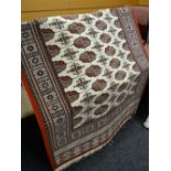 A good modern Bokhara red rug with original label, 120 x 180cms