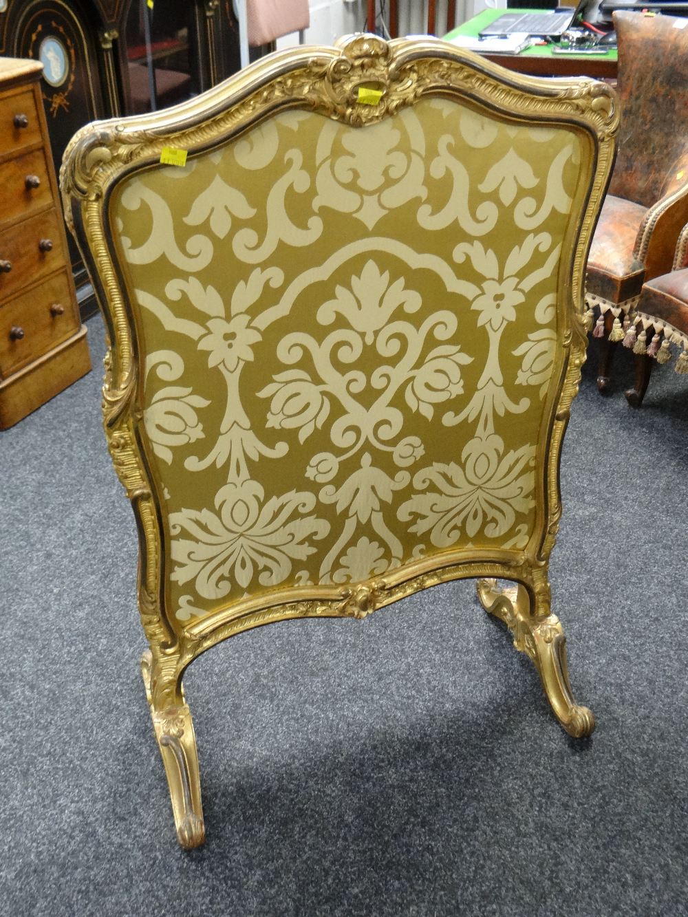 A Rococo style gilded & ebonized carved fire screen with double-side silk fabric panel