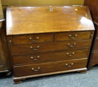 An antique inlaid mahogany bureau composed of three graduated drawers, two short drawers, the sloped