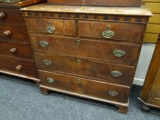 An antique oak chest of three long & two short drawers with marquetry border & brass handles &