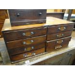 A vintage table top artist's chest with a bank of eight drawers having brass handles