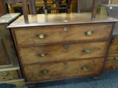 An antique chest of three drawers on bun feet, 108cms wide