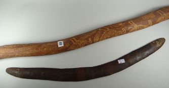 An Aboriginal didgeridoo & boomerang, the didgeridoo with scratched emu & snake decoration, the