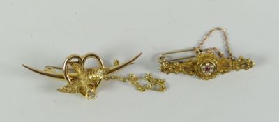 Two gold bar-brooches including swallow & heart example