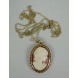 A small oval cameo pendant on a very fine gold necklace