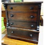 An antique mahogany miniature chest / apprentice chest of four graduated drawers with turned knobs &