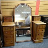 A flame mahogany pedestal dressing table with centre swing mirror & two banks of four drawers