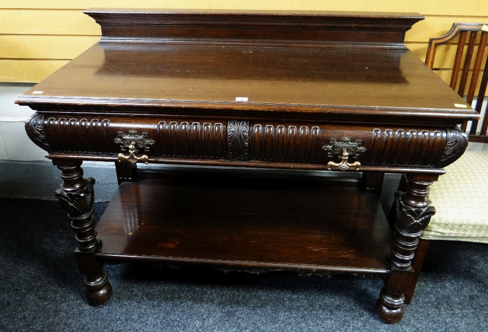 An antique mahogany buffet sideboard with carved features & copper handles, 121cms wide