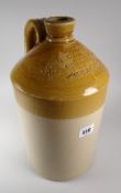 An antique stoneware spirit bottle impressed 'JOHN OWEN JONES WINE AND SPIRIT MERCHANT,