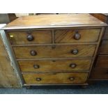 An antique mahogany chest of three long & two short drawers on bun feet & with turned handles,