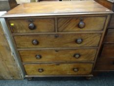 An antique mahogany chest of three long & two short drawers on bun feet & with turned handles,