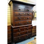 An antique Victorian chest-on-chest composed of six long & two short drawers with carved frieze,