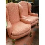 Pair of matching classically upholstered highback winged armchairs