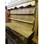 Pine dresser of three base drawers over four cupboard doors
