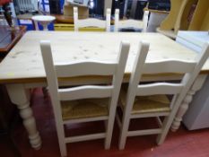 Pine farmhouse table with white painted legs and four rush seated chairs