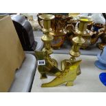 Decorative brass shoes and a pair of brass candlesticks