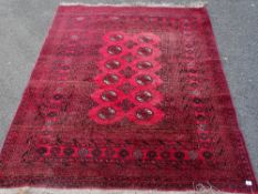 Red ground tassel end rug, 195 x 145 cms