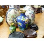 Two cloisonne eggs and two cloisonne vases on hardwood stands