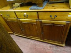Pine sideboard of three drawers over three base cupboards