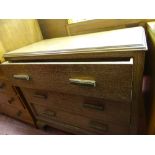 Polished wood three drawer chest with carved detail to handles